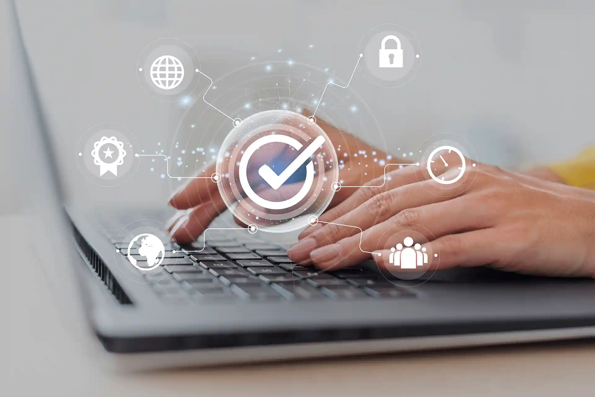 Hands typing on a laptop with a white graphic overlay showing different icons