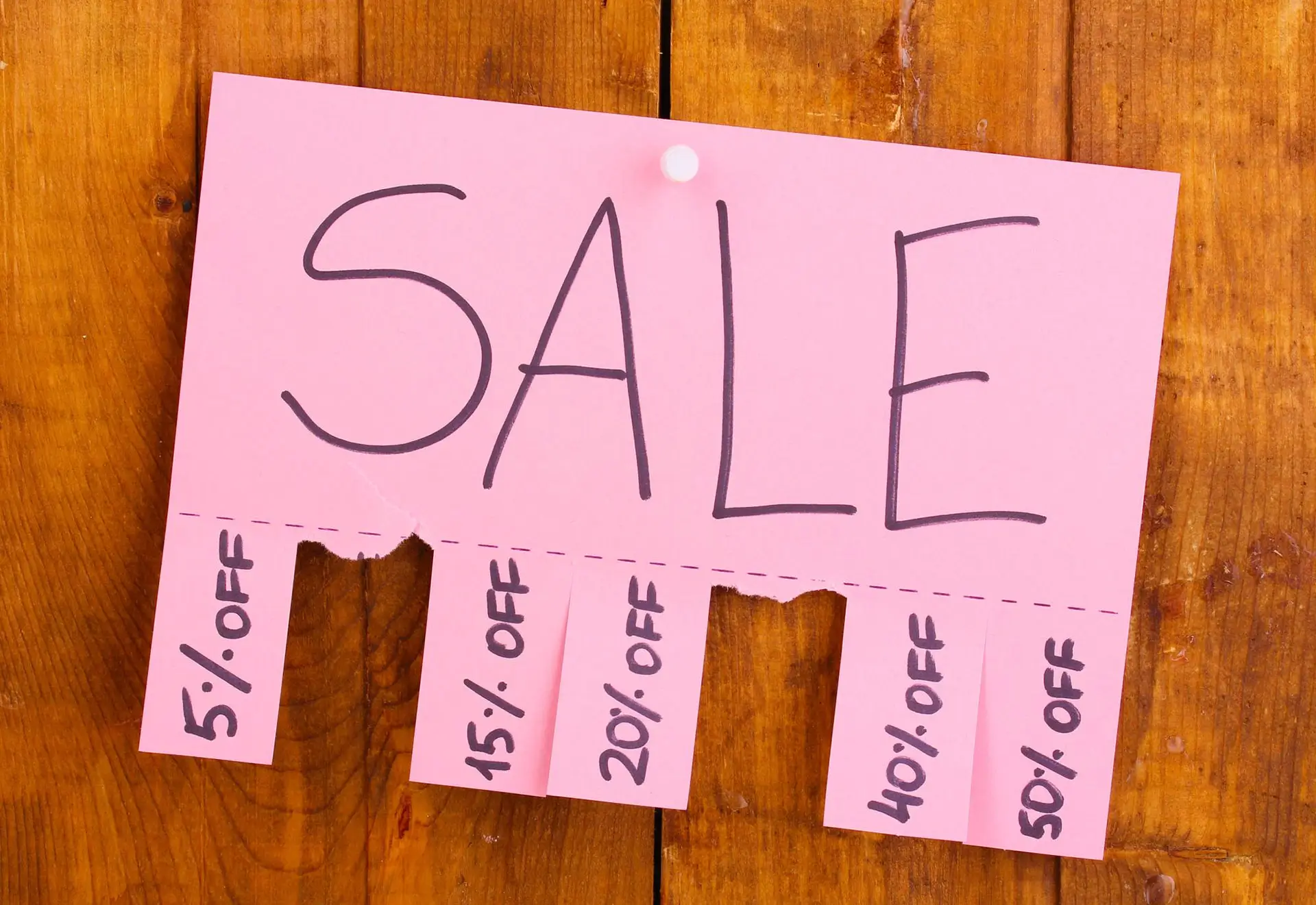Hand written sale sign with different percentages