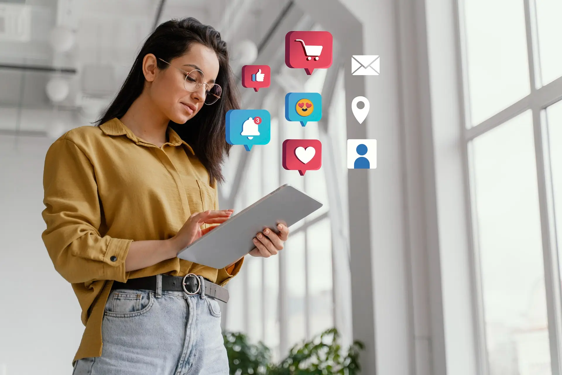 A woman on a tablet with social media icons floating around her