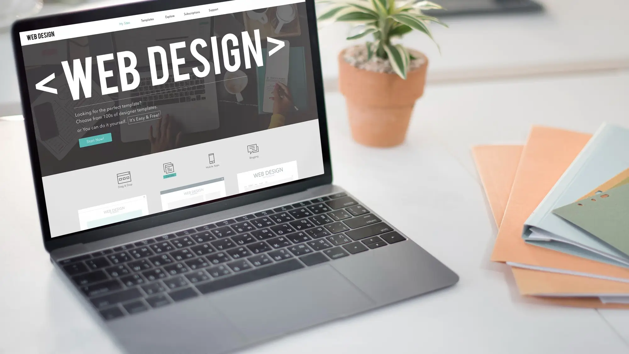 A laptop that's showing a website design in progress